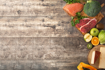 Vitamin A in food on wooden table. Top view. Copy space