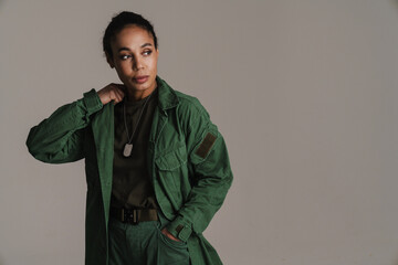 Confident african american soldier woman posing and looking aside