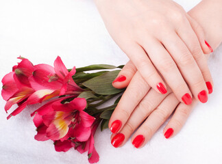 Closeup image of red manicure with flowers