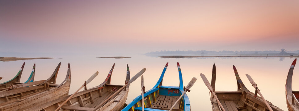 Wooden boats moored in Myanmar - banner background image