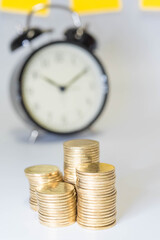 Saving money as a concept. Vintage retro stack of gold coins on the wooden background to represent It's time to do investing for retirement planning.
