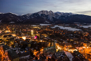 Polish mountains Tatry in Zakopane. Zakopane city at night in winter time in Poland. Night scene in Tatry mountains aerial drone view