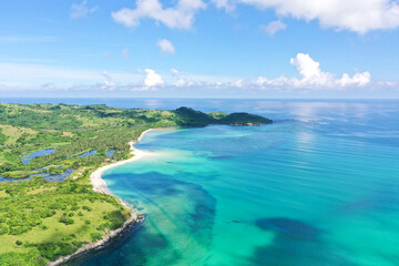 A tropical island with a turquoise lagoon and a sandbank. Caramoan Islands, Philippines.