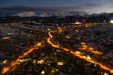 Polish mountains Tatry in Zakopane. Zakopane city at night in winter time in Poland. Night scene in Tatry mountains aerial drone view