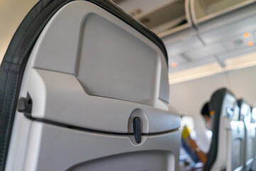 Passenger seat of plane. Soft focus and blurred background of passengers on commercial aircraft ,airplane or plane that airplane cabin interior with seats.