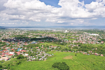 Tacloban, aerial view. Town and sky with cumulus clouds. Asian town by the sea.