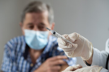 elderly man getting coronavirus vaccine