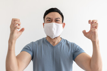 Angry and mad Asian man in face mask on isolated white background.