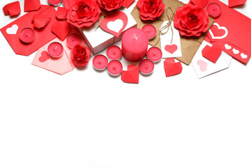 Several pink wax candles, gifts, love letters, 3D handmade red paper roses and hearts on white background. Love, Valentine's, mother's, women's day, relations, romantic, wedding concept