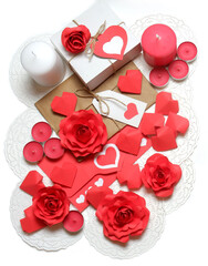 Love, Valentine's, women's day, relations, romantic composition from gifts, love letter, pink and white candles, 3D paper handmade roses and hearts on openwork paper napkins on white background