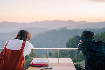 asian couple relax with travel in honeymoon trip with mountain background