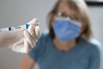 elderly woman getting coronavirus vaccine