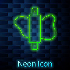 Glowing neon line Rolling pin on dough icon isolated on brick wall background. Vector.