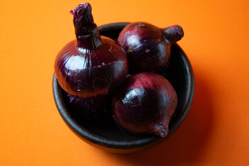 purple onion in orange background