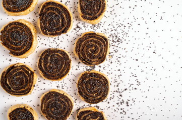 Delicious cookies with poppy seeds on a white background, sprinkled with poppy seeds.