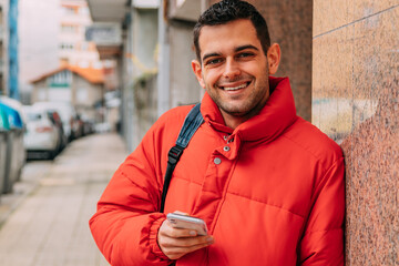 young man using smartphone on the street