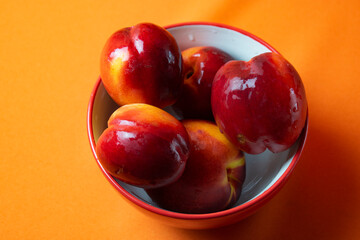 fresh peaches on orange background