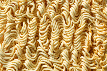 Macro instant raw noodle. Close-up uncooked ramen texture. Food background, top view 