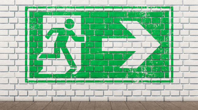 Exit sign on white brick wall