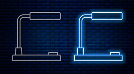 Glowing neon line Table lamp icon isolated on brick wall background. Desk lamp. Vector.