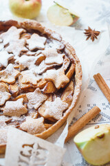 Traditional apple pie on the table with decorations.
