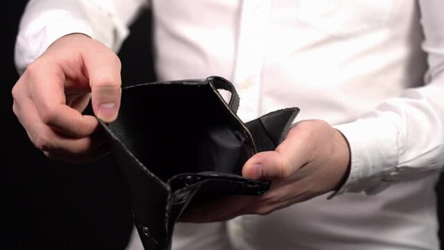 Show Empty Wallet. Man Showing Empty Old Wallet. Demonstrate their Insolvency.