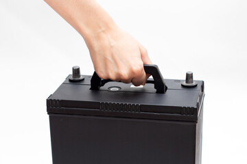 Hand take car battery. Worker changing battery