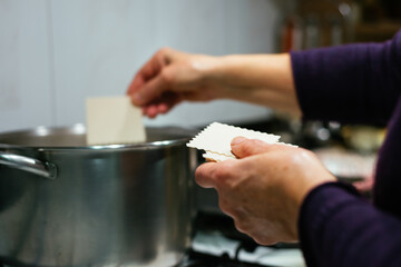 Woman cooking cannelloni at the kitchen