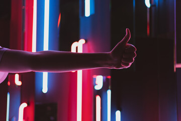 Symbol like on the background of beautiful neon lamps. The concept of approval, success and voting