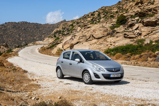 Ios, Greece - September 21, 2020: Silver Opel Corsa on the road in the mountainous part of Ios Island. Cyclades, Greece