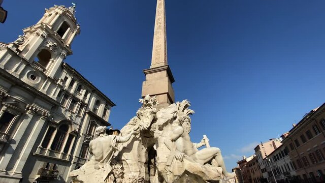 The fountain of the four rivers with the facade of the church of Santa Agnese in Piazza Navona in Rome.
