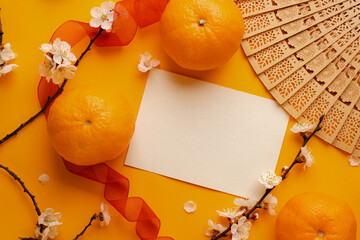 Minimalistic card mockup with cherry branch, flower, red ribbon, blossom, flat lay, top view....