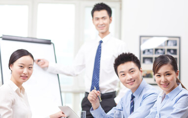 Fototapeta premium Businessman pointing at graph during presentation in boardroom