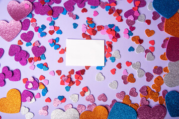 Hearts, arrangement with several colored EVA hearts on a lilac leaf, selective focus, top view.
