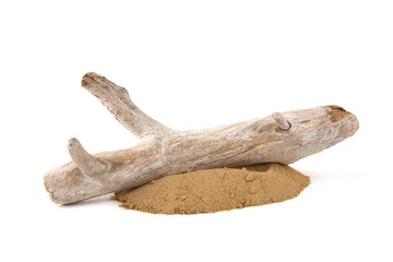 Driftwood on sand isolated on white background. Piece of coastal weathered wood on sand pile.