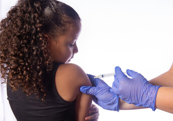 Vaccination of covid, expressive child being vaccinated, white background, selective focus.