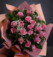 Bridal bouquet with pink roses and small white flowers