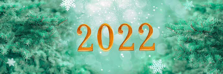 background 2022, happy new year banner, green pine tree branches and snowflakes and golden numbers...