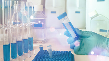 Hand in glove with automatic pipette and samples, panoramic image. Polymerase Chain Reaction PCR...