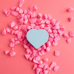 Obraz premium Blue heart and pink stones and background. Pastel decoration for valentine's day. Flat lay.