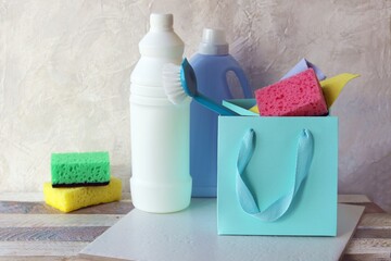 Liquid detergents in plastic bottles, packaging of home cleaning products on the table