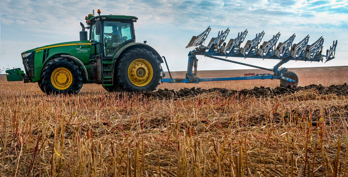 Baykivtsi, Ternopil region, Ukraine - October 18, 2019: John Deere 8370r farm tractor with Lemken plow 8 sections