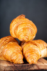 Delicious snack croissant on black background