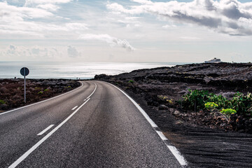 Lonely asphalt road on a sunny day in La Geria, Lanzarote