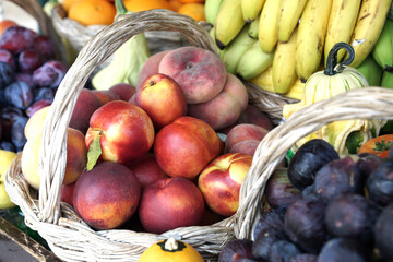 Fruit market. A counter with a variety of fruits and berries in wicker baskets. Selective focus.