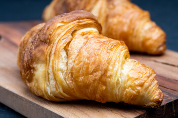 Delicious snack croissant on black background