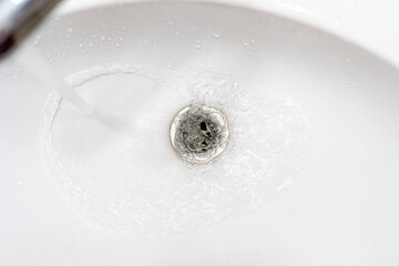 water draining from sink, pouring liquid in the hole