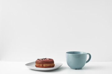Mug and donuts cakes on a white background. Confectionery, coffee shop. Copy space, mock up.