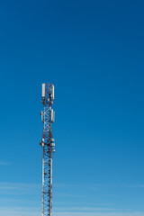 Cell phone tower for network coverage in front of blue sky
