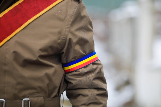 Shallow depth of field (selective focus) with the uniform of a Romanian soldier during an official ceremony on a cold and snowy winter day.